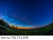 Noctilucent clouds illuminated by the red light of the setting Sun, Albert, Canada. Стоковое фото, фотограф Alan Dyer/Stocktrek Images / ТАСС / Фотобанк Лори