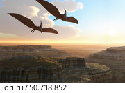 Two Pterodactyl flying dinosaurs soar above a beautiful canyon. Стоковое фото, фотограф Corey Ford/Stocktrek Images / ТАСС / Фотобанк Лори