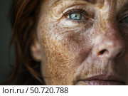 Close up of senior woman showing wrinkles and freckles on face. Стоковое AI-изображение, AI-художник Иван Рябоконь / Фотобанк Лори