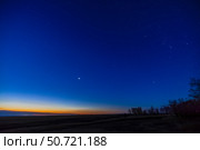 Mercury (low at left), Venus (bright near center) and the winter stars of Orion (at right) in the morning sky. Стоковое фото, фотограф Alan Dyer/Stocktrek Images / ТАСС / Фотобанк Лори