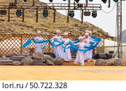 ELANTSY, IRKUTSK REGION, RUSSIA - July 5, 2025: Erdynskie Games - festival of nomadic peoples of Eurasia. Group of Buryat girls in national costumes dance with blue hadaks on open stage near Mount Erd. Редакционное фото, фотограф Виктория Катьянова / Фотобанк Лори