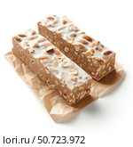 Two bars of almond and hazelnut nougat resting on baking paper. Стоковое AI-изображение, AI-художник Иван Рябоконь / Фотобанк Лори