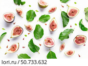 Fresh figs and leaves arranged on white background, creating appealing visual pattern. Стоковое AI-изображение, AI-художник Иван Рябоконь / Фотобанк Лори