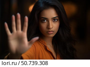 Young woman showing stop sign with hand in dark room. Стоковое AI-изображение, AI-художник Иван Рябоконь / Фотобанк Лори