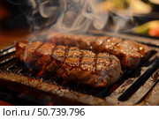Juicy steaks grilling on hot surface, releasing aromatic smoke. Стоковое AI-изображение, AI-художник Иван Рябоконь / Фотобанк Лори