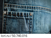 Close up of blue jeans pocket showing stitching and metal button. Стоковое AI-изображение, AI-художник Иван Рябоконь / Фотобанк Лори