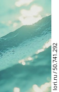 Defocused aqua-mint liquid colored clear water surface texture with splashes bubbles with copy space. Water waves in sunlight background. Стоковое AI-видео, аниматор Sergey Grishin / Фотобанк Лори