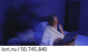 Late Night Work Session in a Cozy Bedroom With Soft Blue Lighting. Стоковое видео, видеограф Ольга Коваленко / Фотобанк Лори