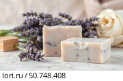 Bars of natural handmade lavender soap next to a bouquet of lavender. Стоковое AI-изображение, AI-художник lyudmila Soloveva / Фотобанк Лори