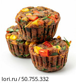 Delicious savory muffins with vegetables piled high on white background. Стоковое AI-изображение, AI-художник Иван Рябоконь / Фотобанк Лори