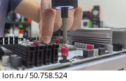 Device repair in an electronics repair lab using tools and components for troubleshooting and maintenance. Стоковое видео, видеограф Darya Komarova / Фотобанк Лори
