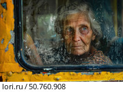 Elderly woman looking through dirty bus window reflecting poverty and hardship. Стоковое AI-изображение, AI-художник Иван Рябоконь / Фотобанк Лори