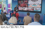 Audience observing a presentation with multimedia visuals in a modern setting. Стоковое видео, видеограф Антон Гвоздиков / Фотобанк Лори