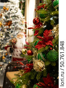 Christmas tree decorated with ornaments and Santa Claus in the background. Стоковое фото, фотограф Оксана Шведкова / Фотобанк Лори
