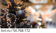 Stylish Christmas background. Black Christmas tree decorations on a Christmas tree. Concept of preparing and decorating for the new year 2026. Стоковое фото, фотограф Photojuli / Фотобанк Лори