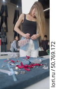 A young woman wears a denim skirt that she created during a workshop. Стоковое видео, видеограф Strunov David / Фотобанк Лори