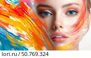 Portrait of a woman with striking blue eyes and vibrant gold accents during a creative art session in a studio setting Generative AI. Стоковое AI-изображение, AI-художник Елена Зубкова / Фотобанк Лори