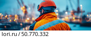 A lone dockworker in safety gear contemplates the bustling port at twilight. Стоковое AI-изображение, AI-художник Данила Большаков / Фотобанк Лори