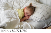 Peaceful adorable baby sleeping on a bed at home. Slumbering little child. Two years old girl sleeps peaceful at domestic room interior background. Serene dream. Cute face close up. Deep kid slumber. Стоковое видео, видеограф Марина Демидюк / Фотобанк Лори