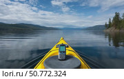 Yellow kayak navigating calm lake with mobile phone on deck. Стоковое AI-видео, аниматор Юрий Поздников / Фотобанк Лори