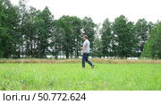 Exploring Nature a Hiker with backpack Strolling Through a Beautiful Field Beneath Vast Blue Sky. Tourist man traverses a scenic field, clear blue sky. Adventure and exploration concept. One person. Стоковое видео, видеограф Марина Демидюк / Фотобанк Лори