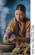 Woman preparing traditional bhutanese medicine with herbs. Стоковое AI-видео, аниматор Юрий Поздников / Фотобанк Лори