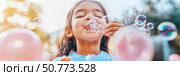 Child Blowing Bubbles Outdoors on Sunny Day: Joyful Moments of Play. Стоковое AI-изображение, AI-художник Данила Большаков / Фотобанк Лори