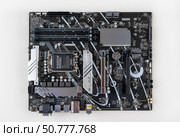 Maykop, Russia - February 18, 2025: New Asus Prime B - 760 plus D4 motherboard on a light gray background top view. Редакционное фото, фотограф Андрей С / Фотобанк Лори