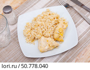 Tender meat of baked chicken breast is garnished with boiled basmati rice. Стоковое фото, фотограф Яков Филимонов / Фотобанк Лори