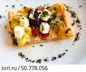 Plate contains sandwich made from of French baguette, stewed Escalibada vegetables, of goat cheese. Стоковое фото, фотограф Яков Филимонов / Фотобанк Лори