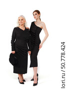 Two Women Wearing Elegant Black Dresses Pose in a Bright Studio. Стоковое фото, фотограф Aleksandr Golubev / Фотобанк Лори