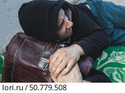 A homeless marginal in dirty clothes living on the street. Стоковое фото, фотограф Михаил Яковлев / Фотобанк Лори