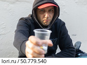 Sad homeless man begs for money at the street. Стоковое фото, фотограф Михаил Яковлев / Фотобанк Лори