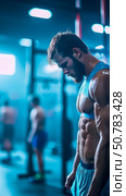 A Sweaty Athlete Rests After an Intense Workout in a Modern Gym. Стоковое AI-изображение, AI-художник Данила Большаков / Фотобанк Лори