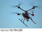 Professional drone flying in a clear blue sky. Стоковое AI-изображение, AI-художник Иван Рябоконь / Фотобанк Лори