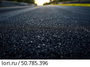Fresh asphalt road texture with water drops drying in the sun. Стоковое AI-изображение, AI-художник Иван Рябоконь / Фотобанк Лори