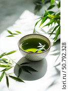 Fresh Green Tea in a Bowl Surrounded by Leaves on a Light Surface. Стоковое AI-изображение, AI-художник Юлия Гапеенко / Фотобанк Лори