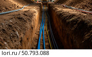 Underground trench with new internet cable installation. Digging a ditch for urban infrastructure and utility lines. Earthwork. Стоковое AI-изображение, AI-художник Анжелика Самсонова / Фотобанк Лори