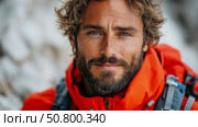 Adventurer's close-up: A rugged man with a beard, portrayed with his red coat. Стоковое AI-изображение, AI-художник Данила Большаков / Фотобанк Лори