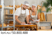 Man and woman sellers in bakery make calculations, work with paper documents and count using phone. Стоковое фото, фотограф Яков Филимонов / Фотобанк Лори