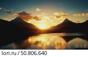 Majestic sunrise over mountains and lake reflecting colors. Стоковое AI-видео, аниматор Андрей Бажанов / Фотобанк Лори