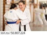 Positive young girl applying throwing technique during judo classes. Стоковое фото, фотограф Яков Филимонов / Фотобанк Лори
