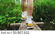 A boy crosses a river on a bridge. Стоковое видео, видеограф Igor Skripachev / Фотобанк Лори