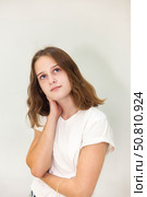 Teen Actress Expresses Deep Emotions in a Creative Indoor Setting With a Blank Backdrop. Стоковое фото, фотограф Aleksandr Golubev / Фотобанк Лори