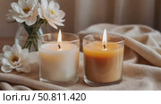 Two burning candles on a background of flowers. Стоковое AI-видео, аниматор ketpro.design / Фотобанк Лори