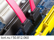 Материнская плата компьютера и соединительные кабели SATA. Computer motherboard, electronic components on circuits board. Стоковое фото, фотограф Татьяна Д / Фотобанк Лори
