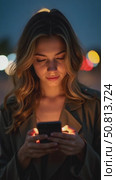 Beautiful and inspiring young woman over epic night sea background. Millennial female with screen lit face, cool and trendy teenager looking woman. Smartphone application market, Стоковое AI-видео, аниматор Sergey Grishin / Фотобанк Лори