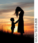 Silhouette of mother and son staying on the hilltop with sunset on background. Стоковое AI-изображение, AI-художник Денис Глагазин / Фотобанк Лори