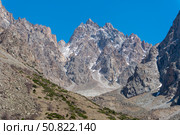 Ala-Archa Park, Towering jagged mountains dominate the landscape with steep rocky faces patches of snow ideal for challenging trekking mountaineering alpinism and backcountry adventure experiences. Стоковое фото, фотограф Андрей Ка / Фотобанк Лори