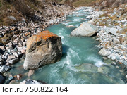 Ala-Archa Park, Fast flowing glacial river with clear blue water, Stones and rugged landscape, ideal for mountaineering, backcountry exploration, and challenging outdoor journeys in pristine nature. Стоковое фото, фотограф Андрей Ка / Фотобанк Лори